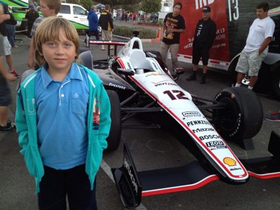 Anthony standing next to a race car